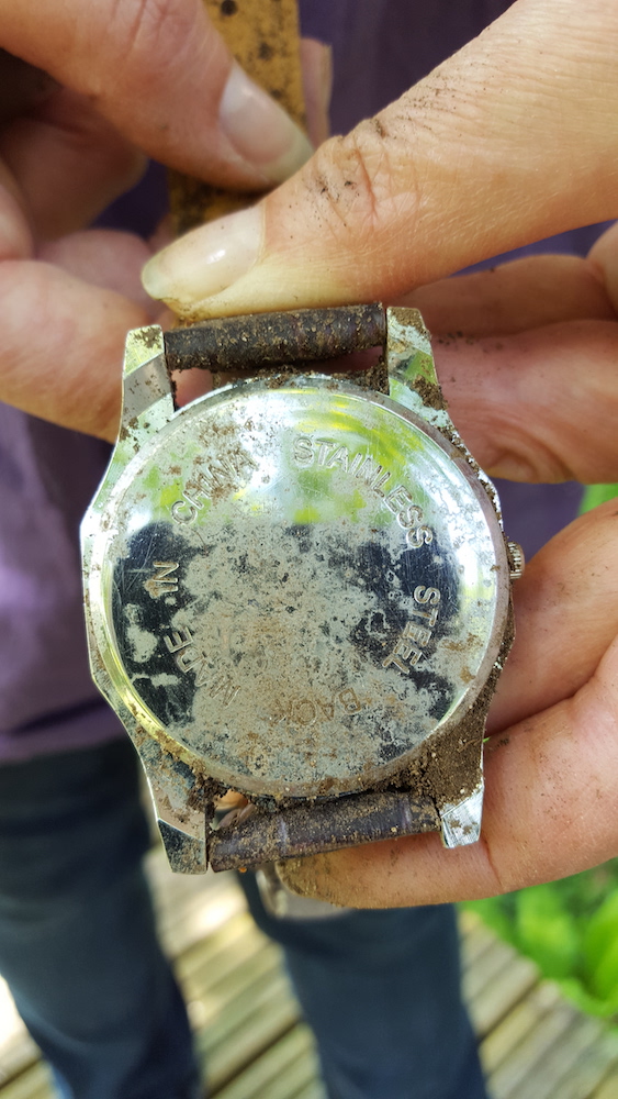 back of the metal watch with rust