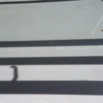shadows and white lines drawn on the studio floor
